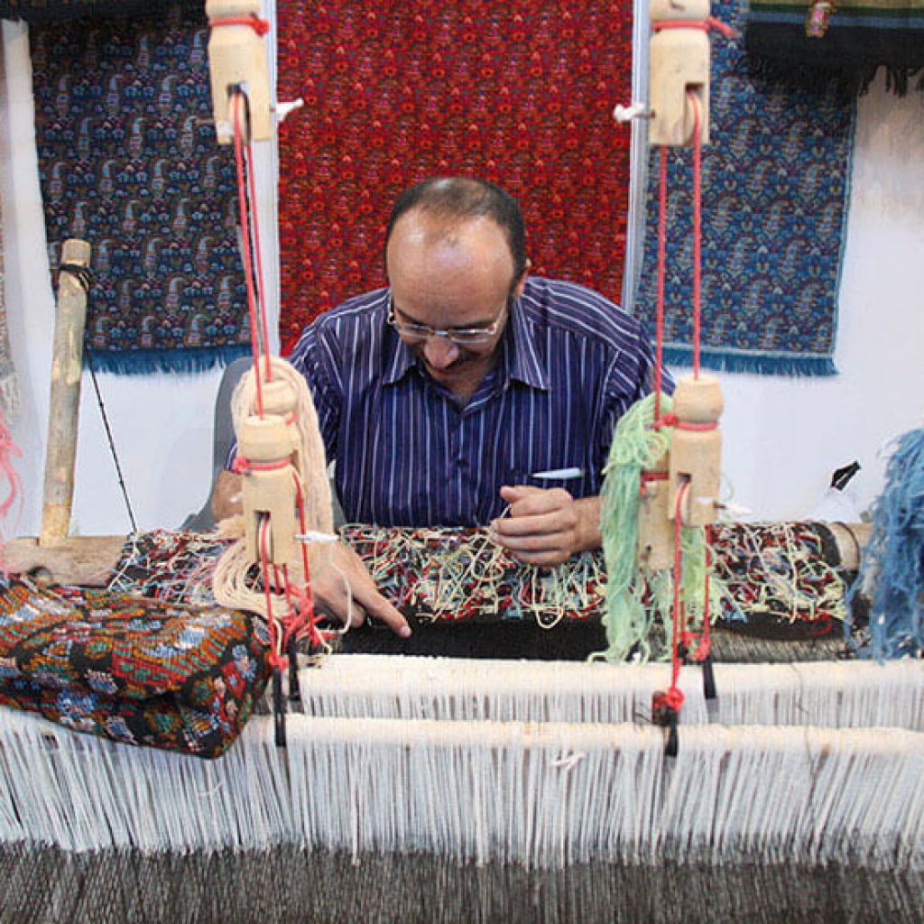 Compassimo-A man weaving Persian carpet