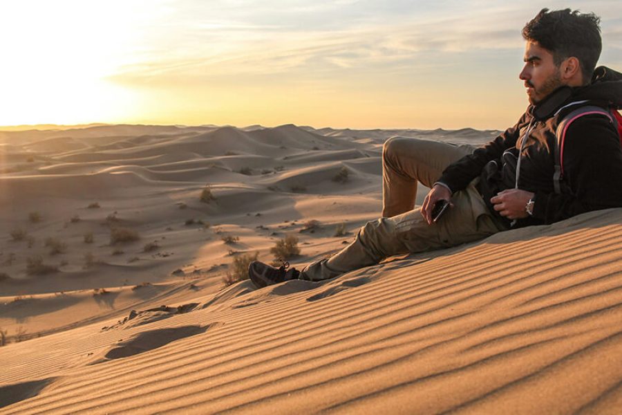 Compassimo-A Tourist watching the beauty of Sand dunes in Varzaneh Desert-Iran