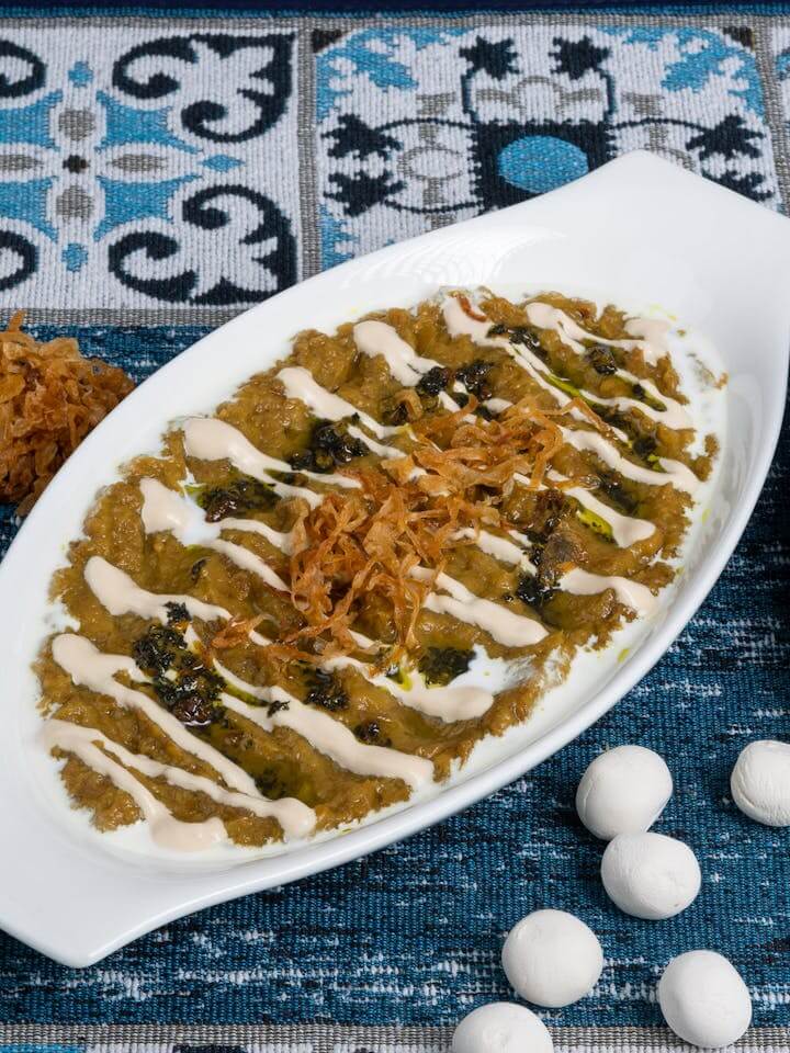 Compassimo-Delicious eggplant dish topped with creamy sauce and herbs