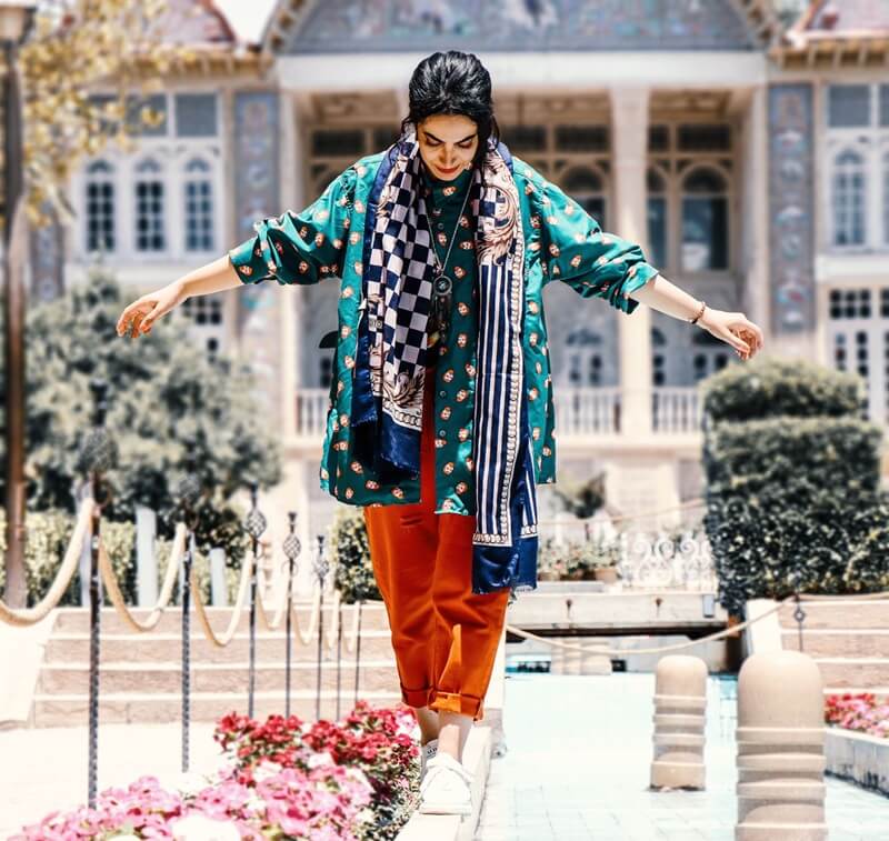 Compassimo-Trendy woman balancing gracefully at Eram Garden-Shiraz-Is Iran Safe